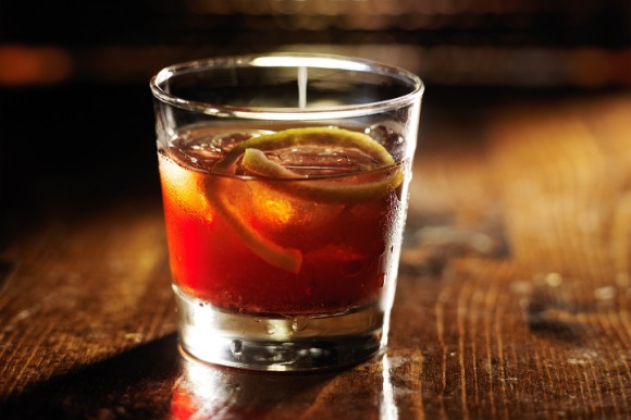 sazerac cocktail on dark wooden background